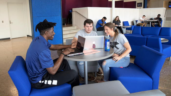 Three students in studying in Hass-Darr Hall