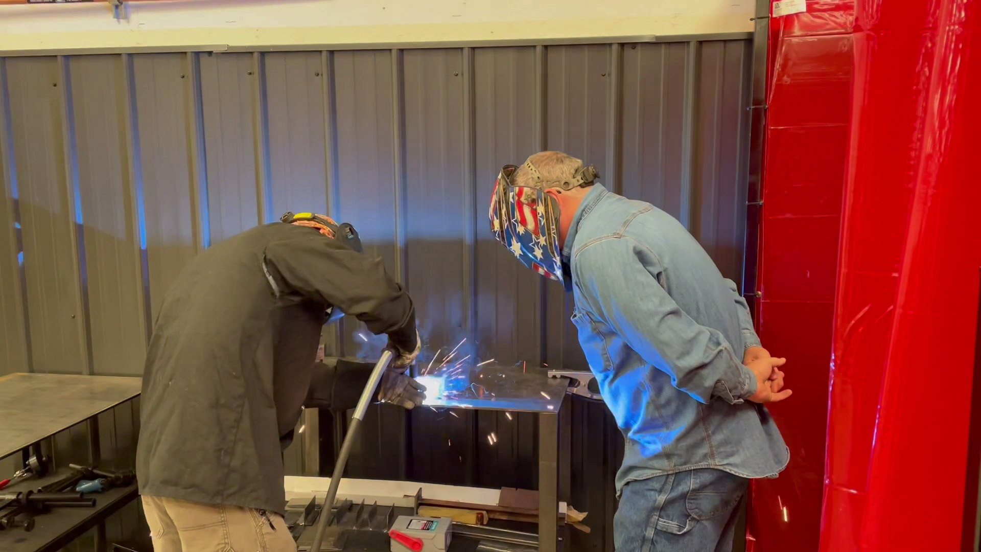 Student with welding torch sparks during instruction