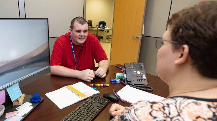 Image of a student receiving advice from their support coordinator.