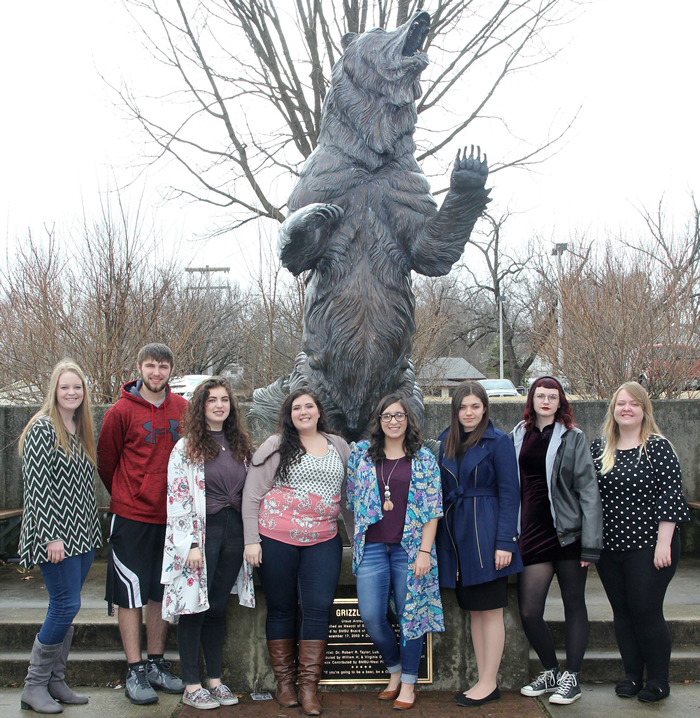 TRIO students pose in front of the Grizzly statue.