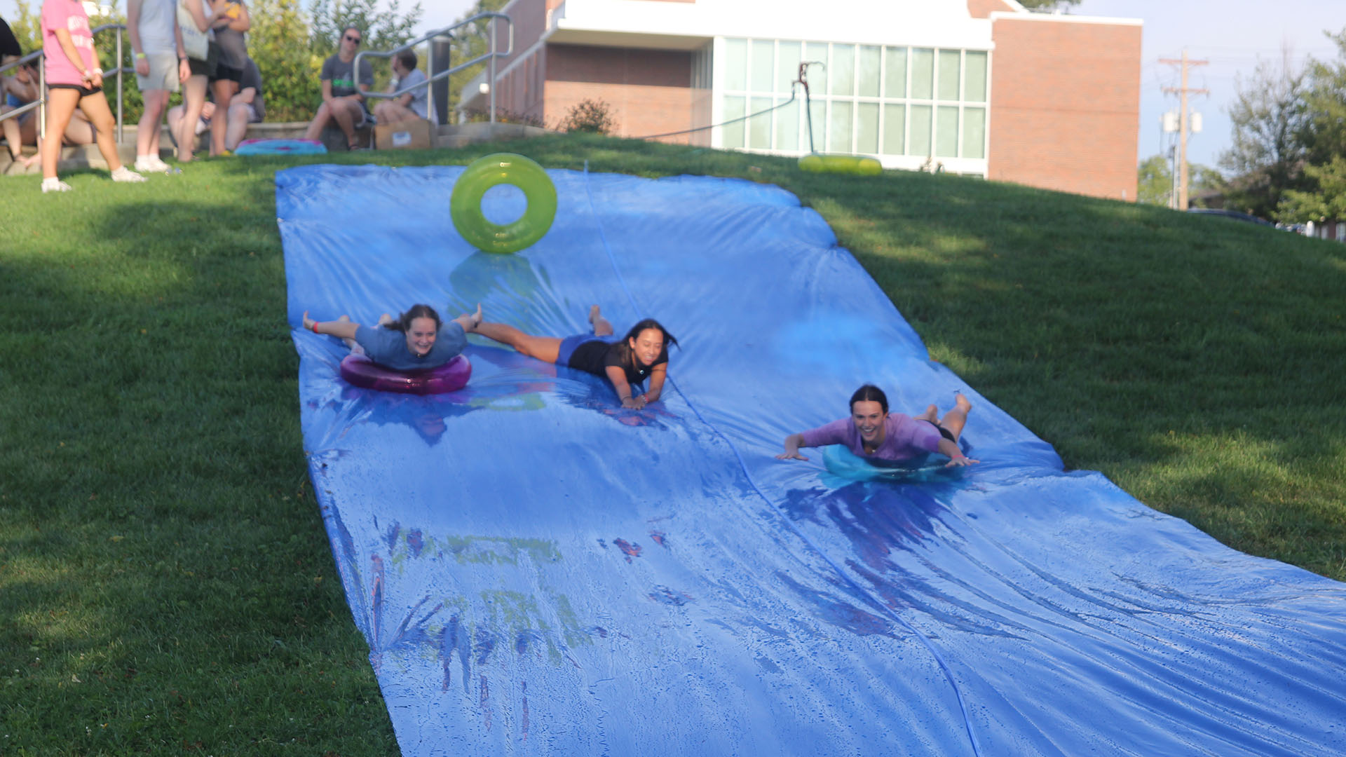 3 Students going down a waterslide together