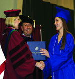 A student receiving their diploma during the graduation ceremony
