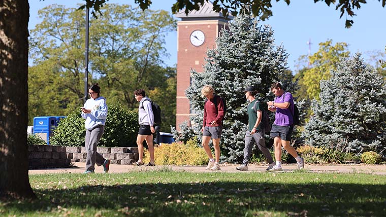 Students Walking Bell Tower in the background