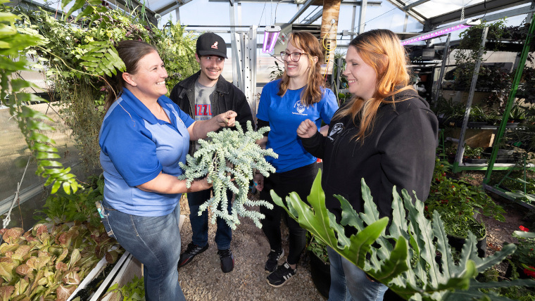 faculty and students learning in the greenhouse