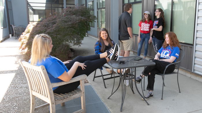 students sitting in an outdoor patio