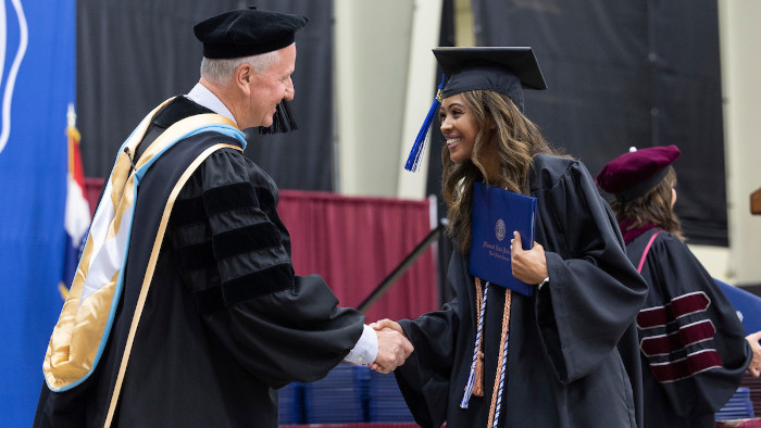 Dr. Lancaster shaking hand of graduate