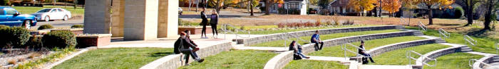Students in Fall at the amphitheater by the bell tower