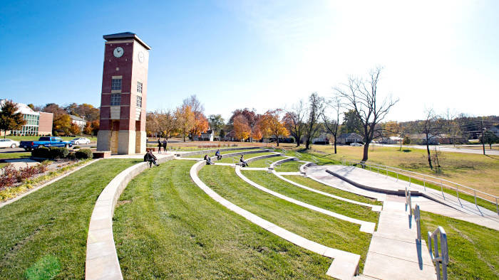 Students in the fall by the Amphitheater and Bell tower