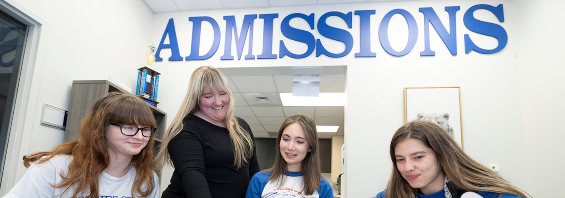 Three students in the Admissions office