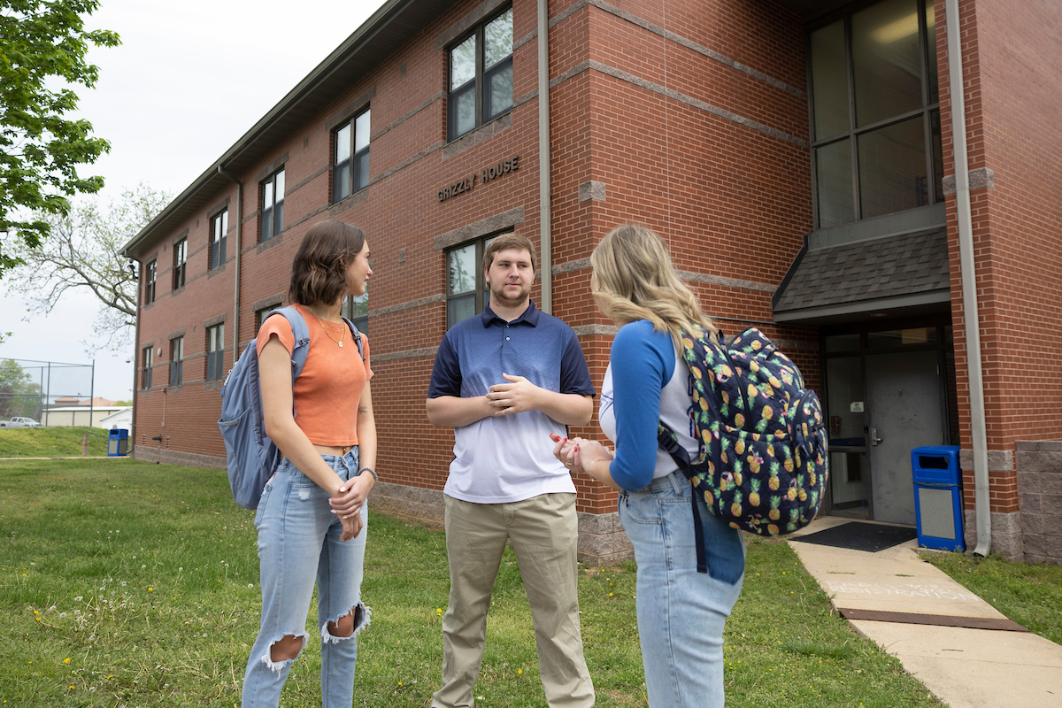 Students standing outside the front of the building 