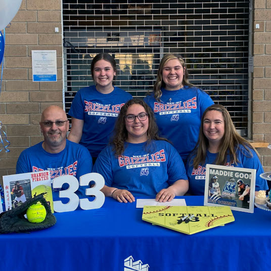 Grizzly Softball recruit Madison Good and family pose for a picture wearing Grizzly Gear after Madison signed her national letter of intent 