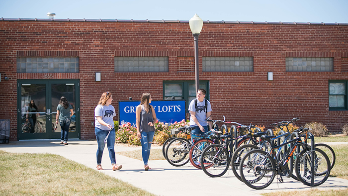 Students utilize the bike rack outside of the Grizzly Lofts