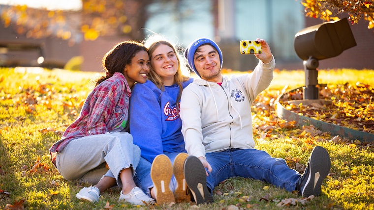 Students taking selfie on a fall day