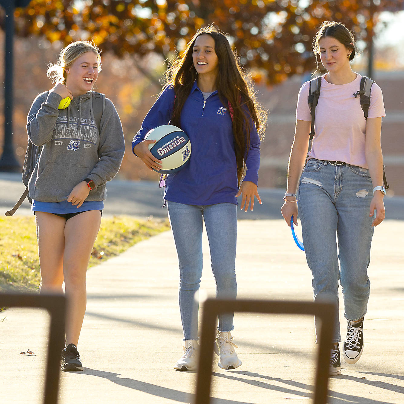 Three students walk by the student recreation center