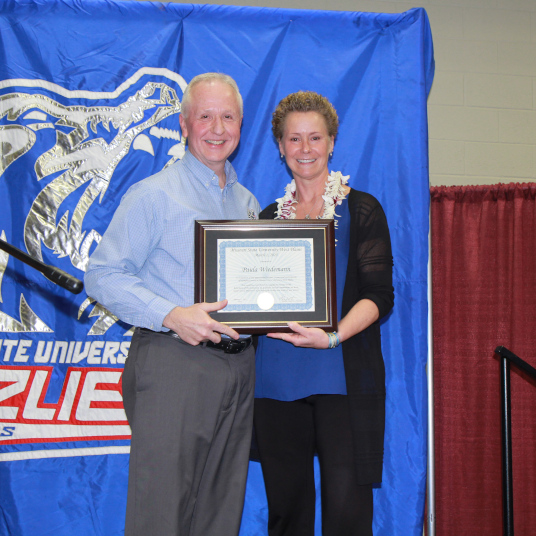Chancellor Dennis Lancaster and Grizzly Volleyball head coach Paula Wiedemann at her retirement celebration