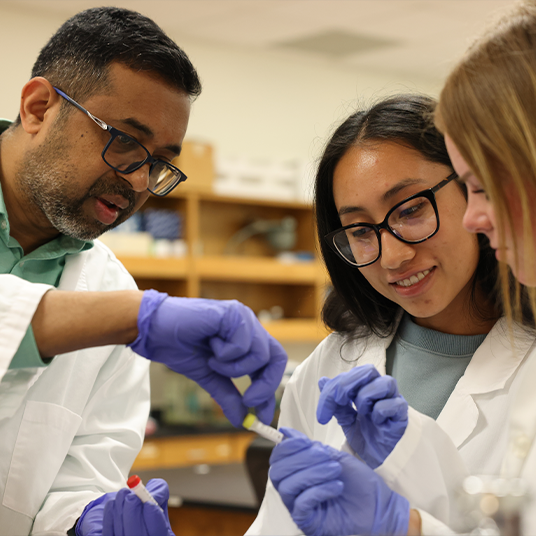 Students working in a science lab classroom with Dr. Sharath Rongali