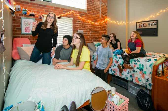 Group of students hanging out in a residence hall room